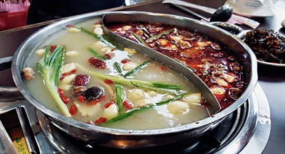 Herbal soup on one side and Spicy soup in the other.
